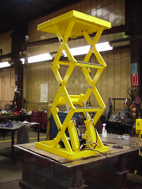 Yellow lift table in raised position