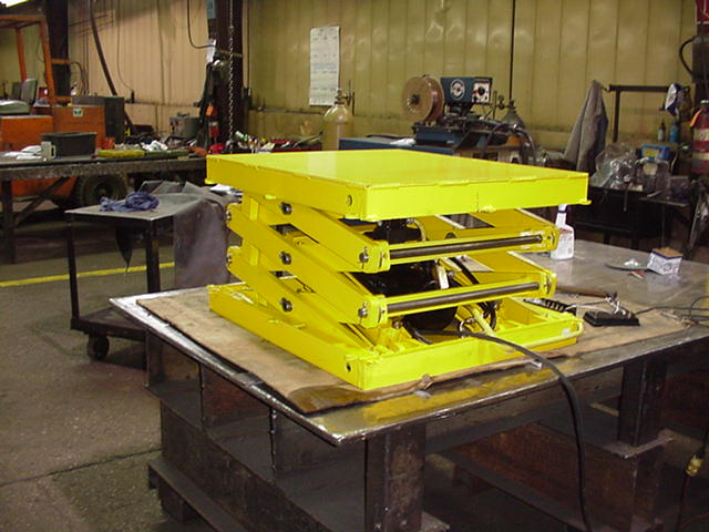 Yellow lift table in lowered position